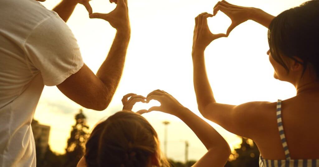 Happy Asian family in Singapore forming a heart shape, representing trust and unity with Moneyplus
