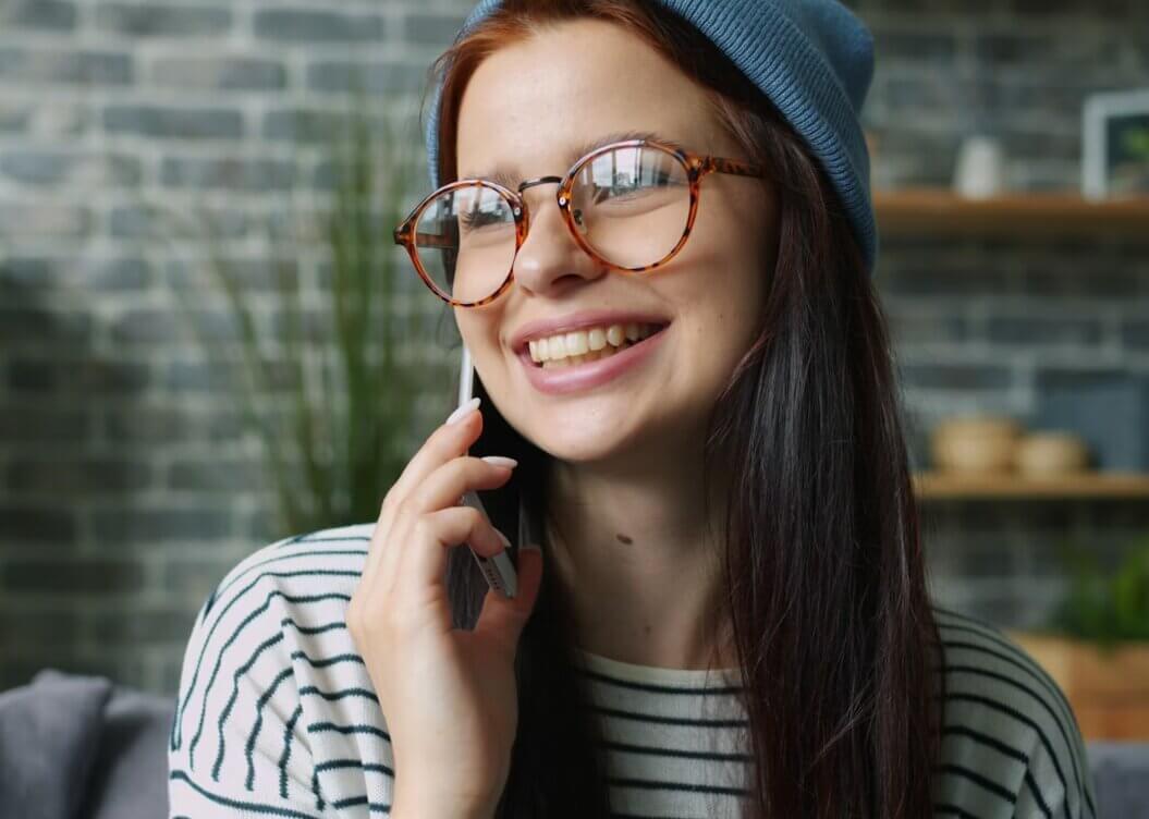 Customer smiling while receiving a personal loan Singapore approval notification from Moneyplus Capital in Singapore on a mobile phone
